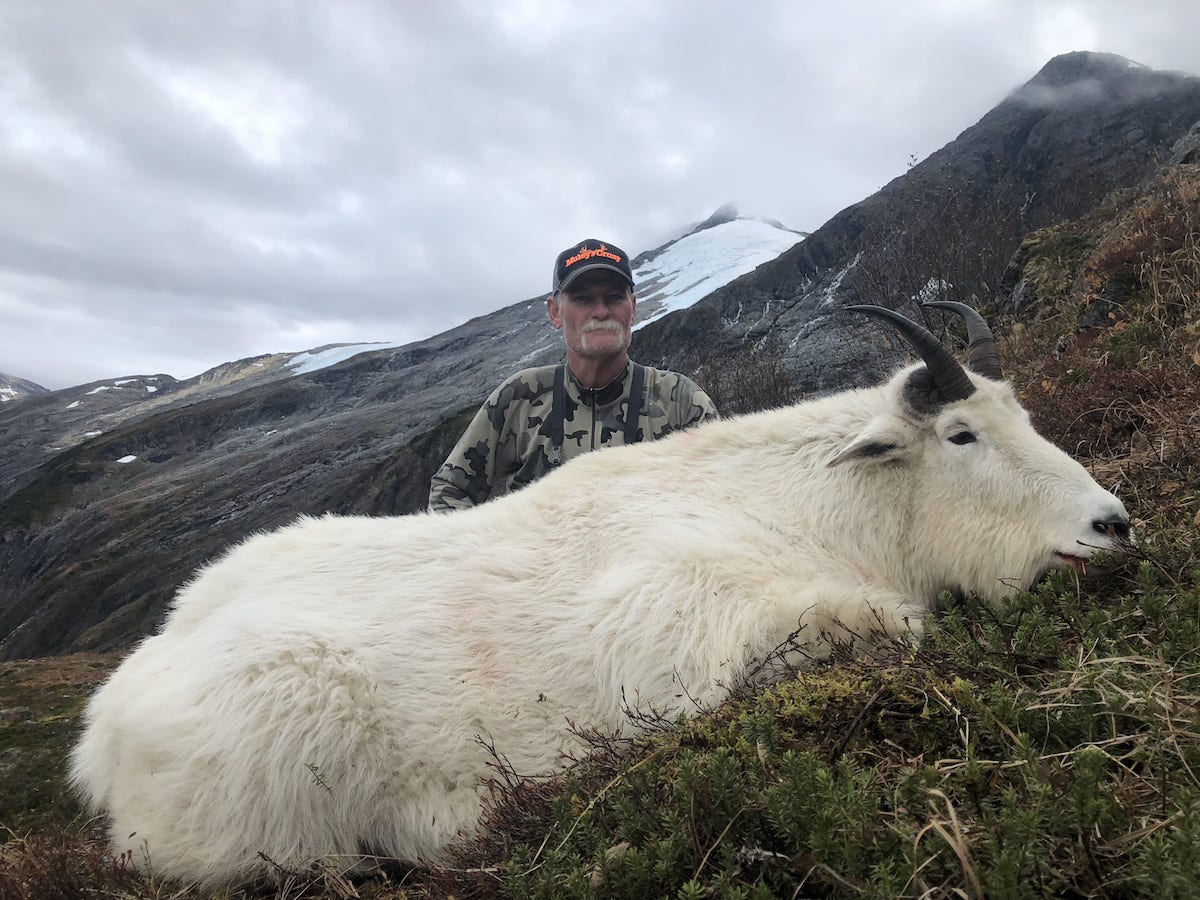 Picture of man with trophy sized Canada Mountain Goat hunted near the Alaskan border.